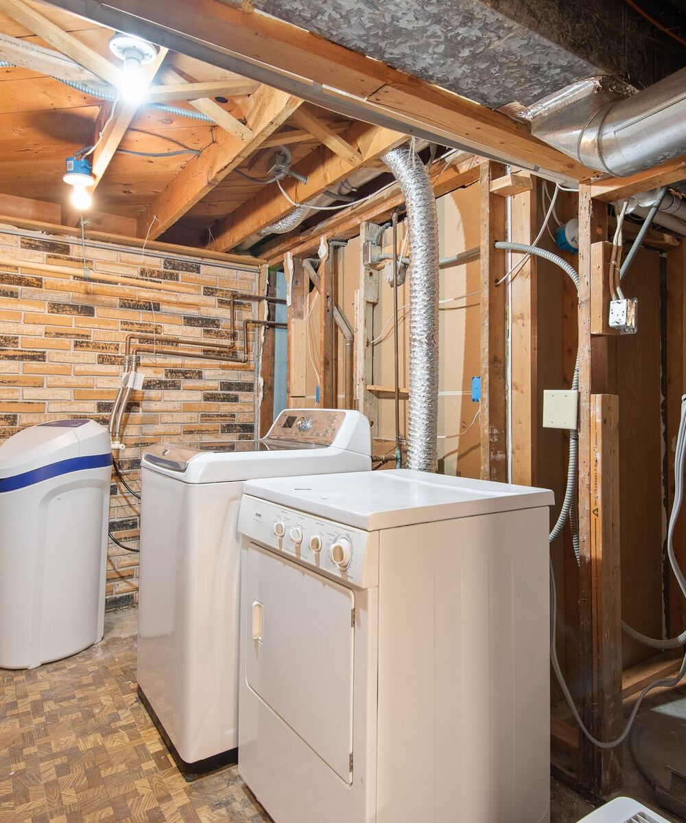 Example of a top-load washer and dryer in an unfinished basement